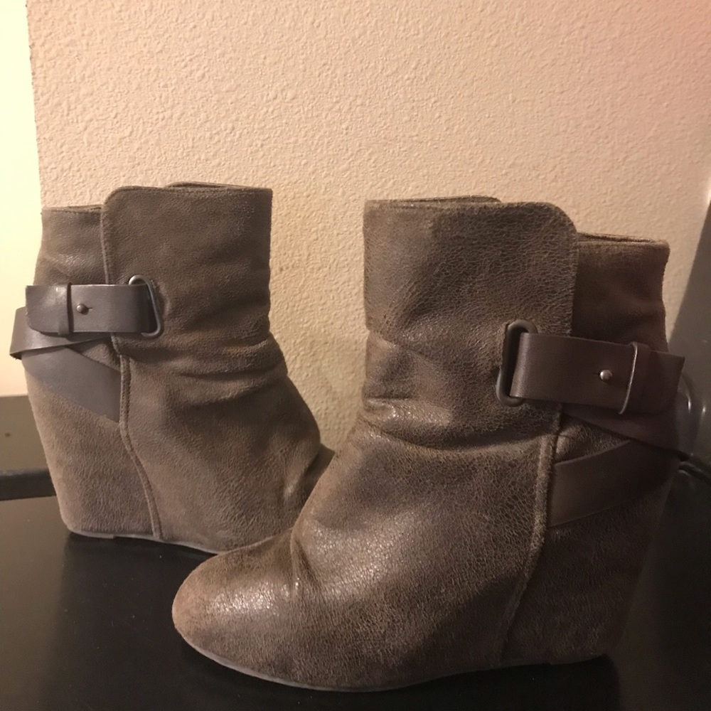 aldo booties with brown leather accent details.